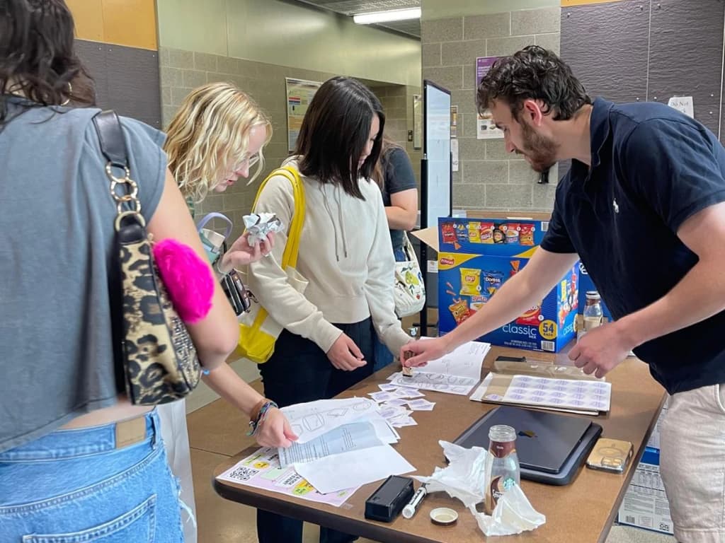 Students visiting the DSAIC table at a campus tabling event